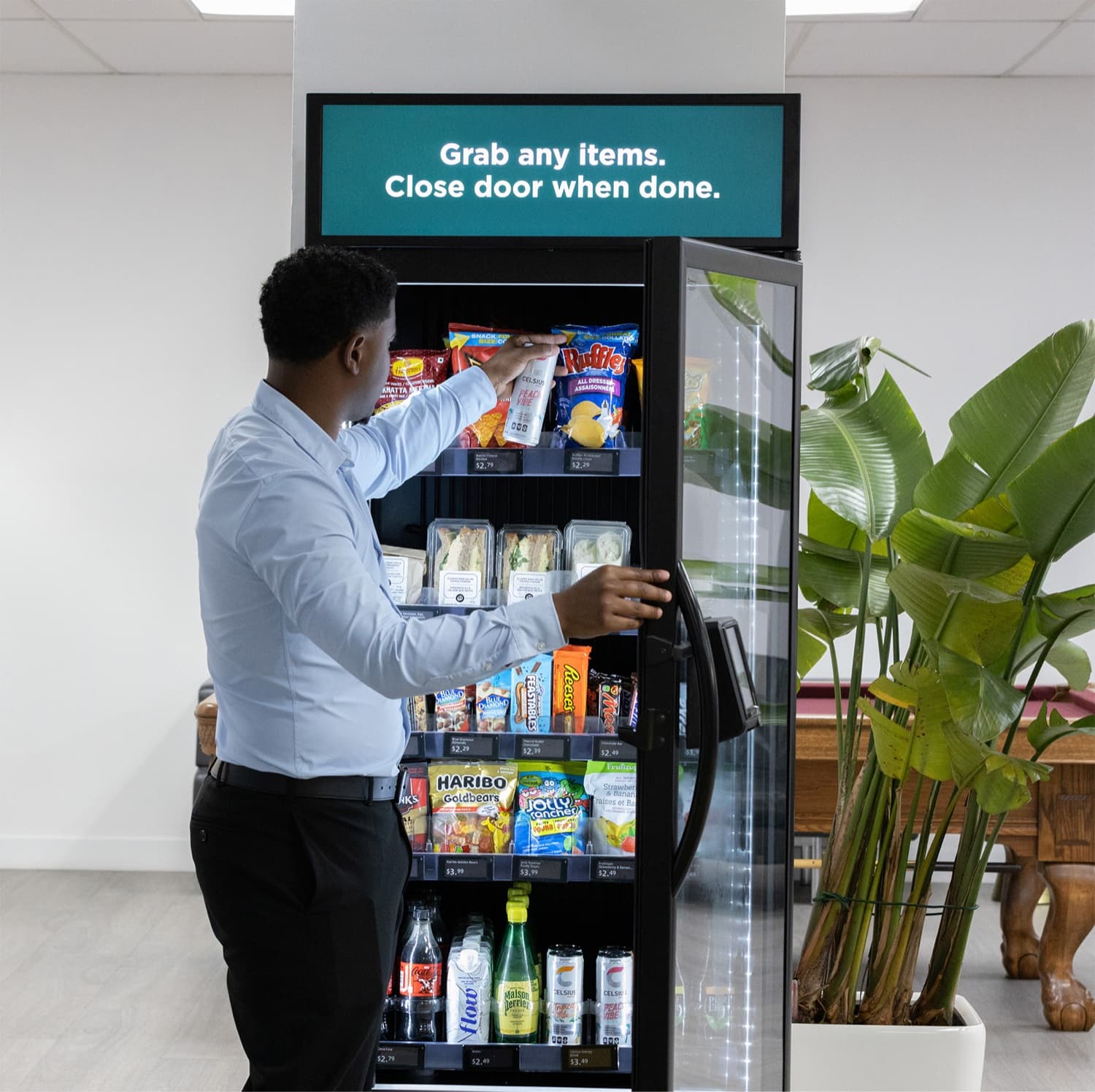 A customer selecting an item from a modern self-serve market